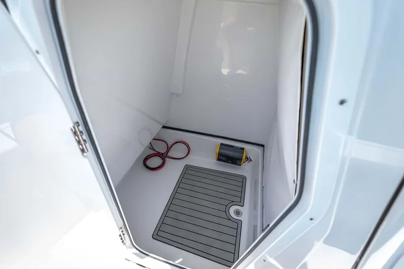 Slide: The Image of Manufacturer Provided Image: 2022 Sportsman Masters 247 Bay Boat storage compartment with mat and coiled rope. - 36