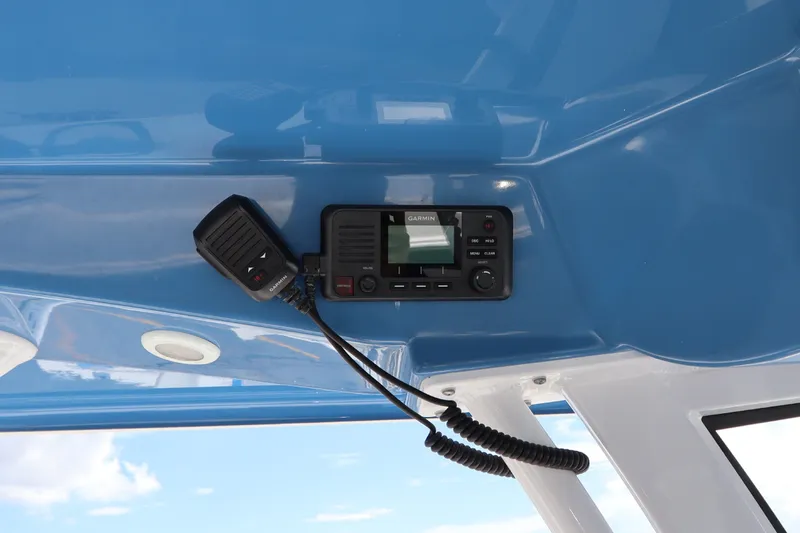 Slide: The Image of Garmin radio installed on 2022 Sportsman Masters 247 Bay Boat's blue interior. - 23