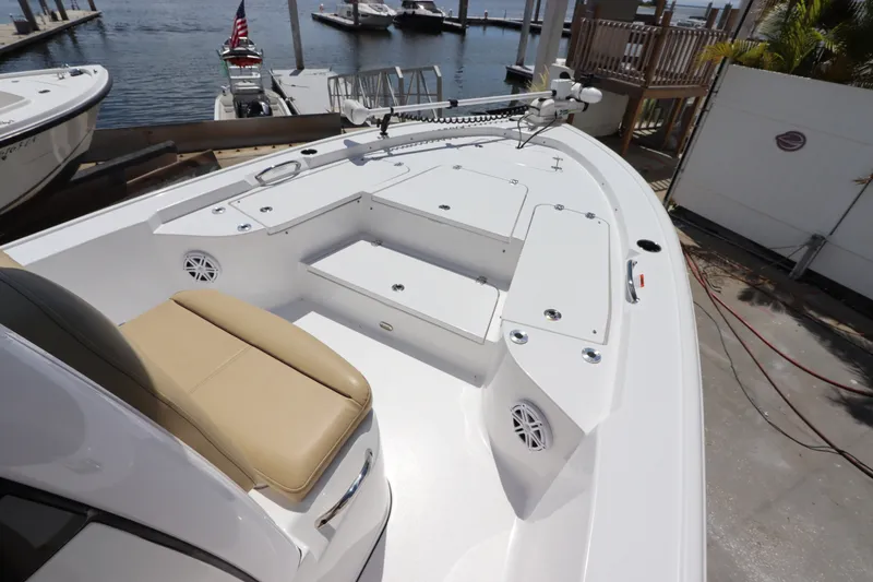 Slide: The Image of 2022 Sportsman Masters 247 Bay Boat with spacious deck and seating at marina. - 26