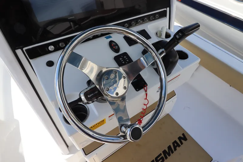 Slide: The Image of Steering console of 2022 Sportsman Masters 247 Bay Boat with chrome wheel and controls. - 20