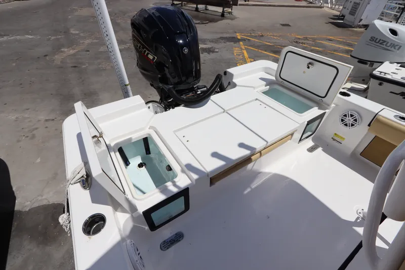 Slide: The Image of 2022 Sportsman Masters 247 Bay Boat with open storage compartments and Yamaha outboard motor. - 10