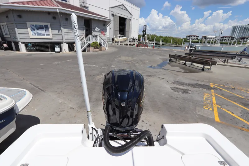 Slide: The Image of 2022 Sportsman Masters 247 Bay Boat at marina, showcasing powerful outboard motor. - 9