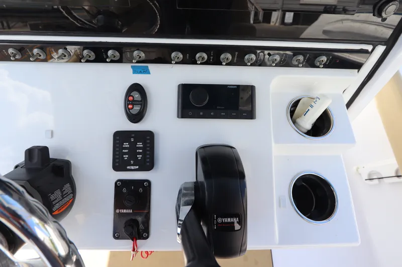 Slide: The Image of Control panel of 2022 Sportsman Masters 247 Bay Boat with Yamaha throttle and cup holders. - 21