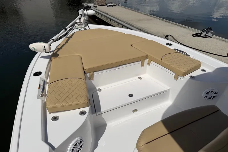 Slide: The Image of 2022 Sportsman Masters 247 Bay Boat with tan cushioned seating and trolling motor. - 25
