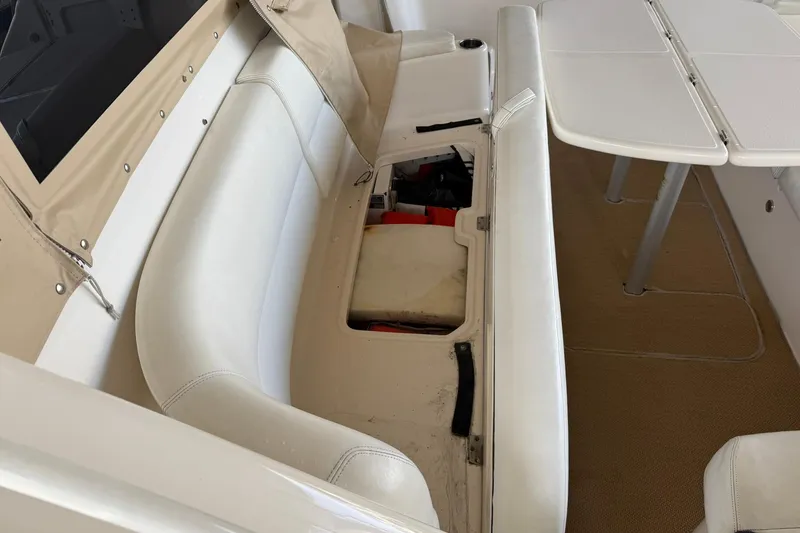 Slide: The Image of 2011 Tiara Yachts 4500 Sovran interior seating with storage compartment open. - 29