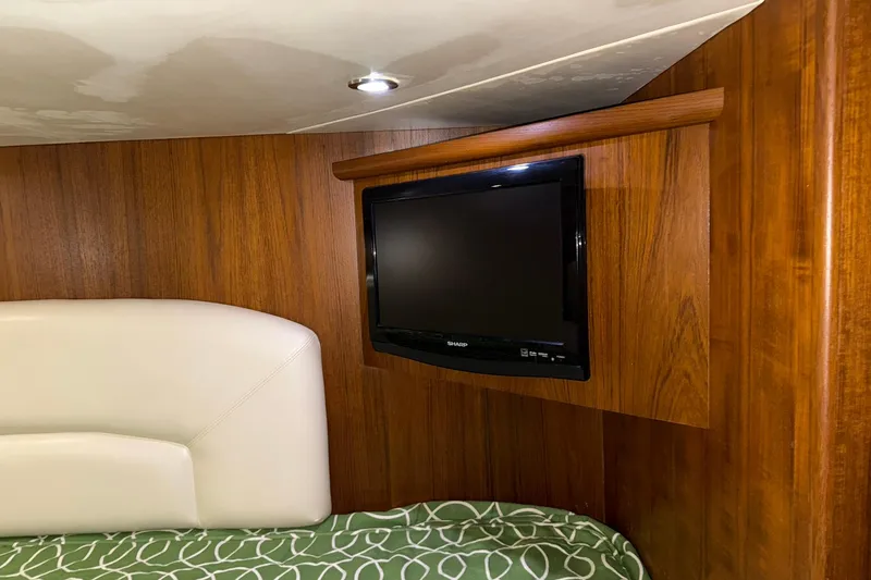 Slide: The Image of Interior of 2011 Tiara Yachts 4500 Sovran with TV and wood paneling. - 76