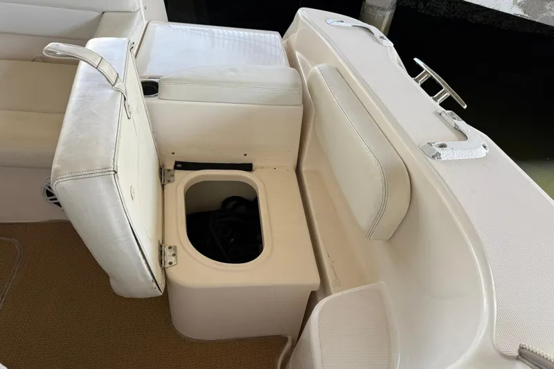 Slide: The Image of 2011 Tiara Yachts 4500 Sovran seating area with storage compartment open. - 27