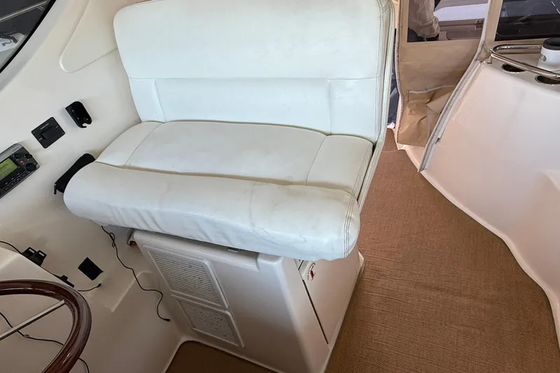 Slide: The Image of Captain's seat on 2011 Tiara Yachts 4500 Sovran, featuring white upholstery and control panel. - 36