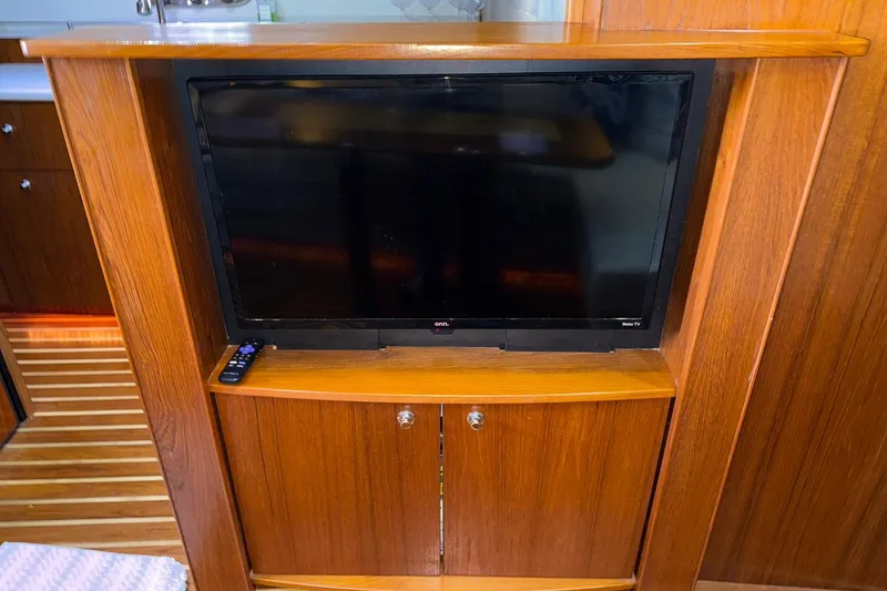 Slide: The Image of Entertainment center with TV and remote in 2011 Tiara Yachts 4500 Sovran interior. - 47