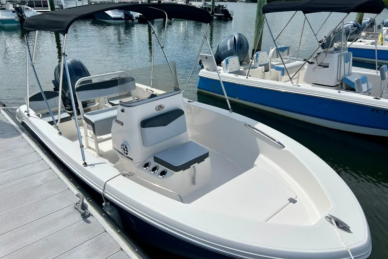 Slide: The Image of 2025 Robalo R160 Center Console boat docked, featuring sleek design and spacious seating. - 4