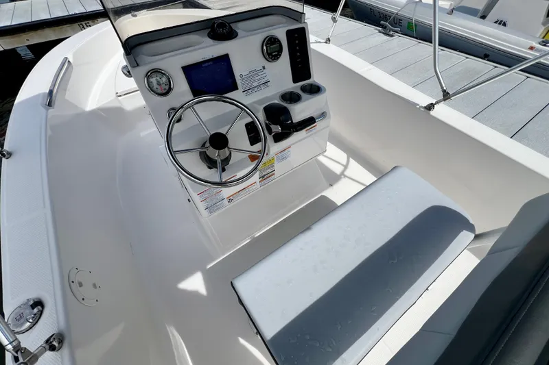 Slide: The Image of 2025 Robalo R160 Center Console boat interior with steering wheel and controls. - 7