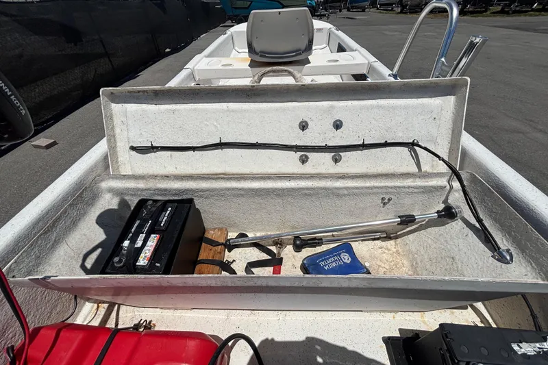 Slide: The Image of 2010 Carolina Skiff JV15TH boat interior with battery and storage compartment. - 26
