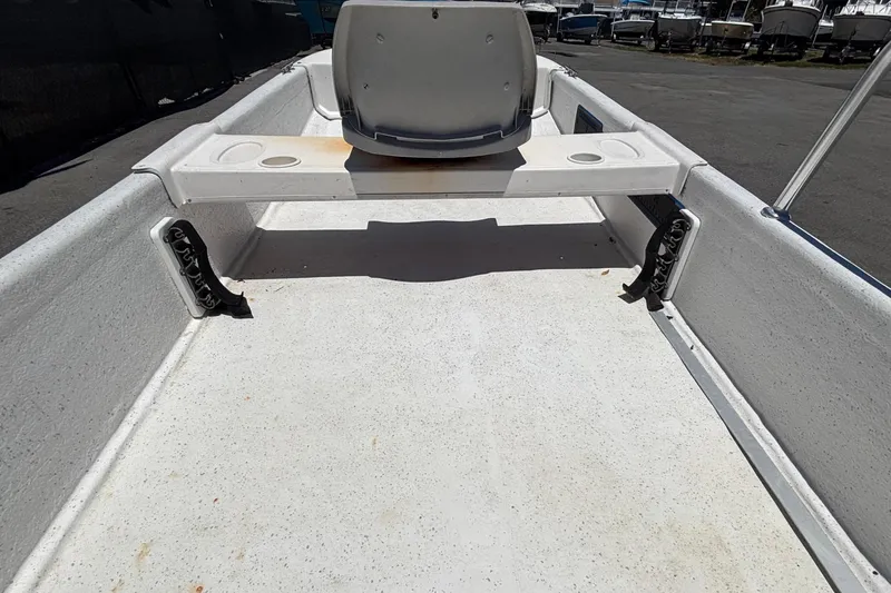 Slide: The Image of An empty boat deck with a seat and steering controls. - 27
