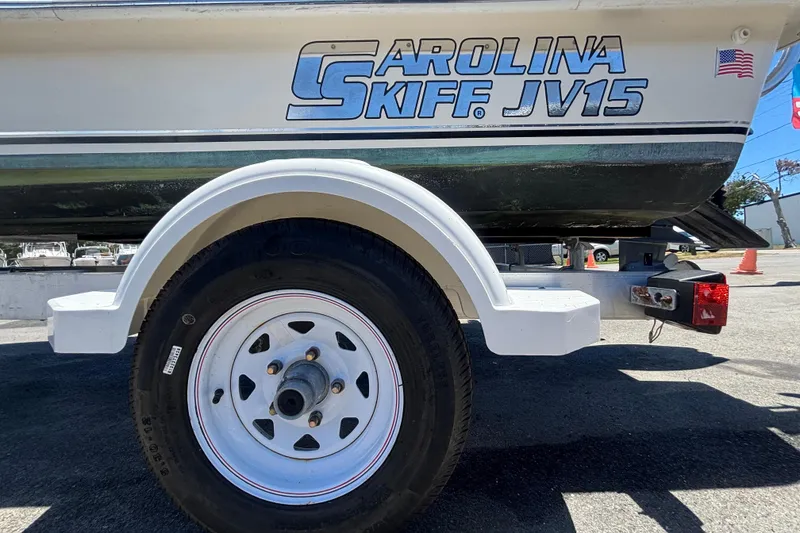 Slide: The Image of 2010 Carolina Skiff JV15TH boat on trailer, close-up of wheel and hull. - 37