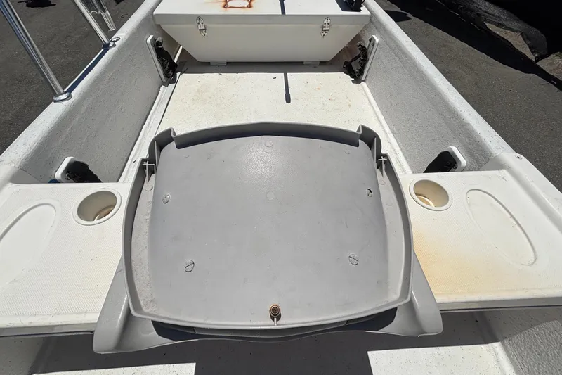 Slide: The Image of A boat with a gray seat and white deck. - 16