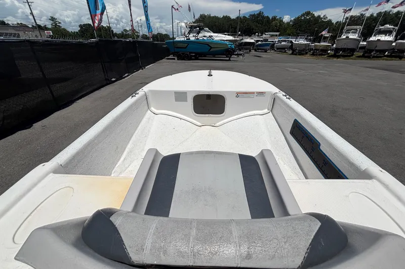 Slide: The Image of 2010 Carolina Skiff JV15TH boat interior view at a marina with other boats. - 29