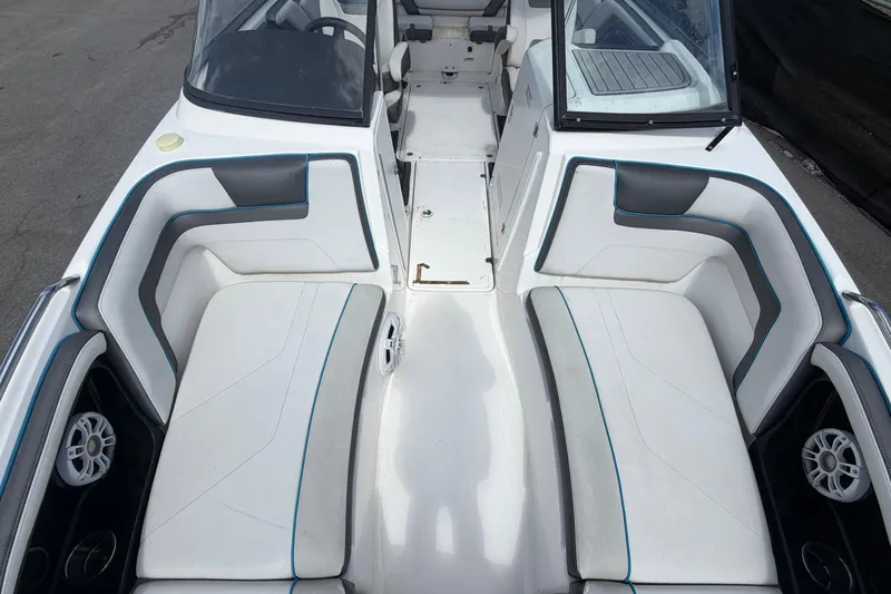 Slide: The Image of 2020 Yamaha Boats AR240 interior with white and gray seating, featuring speakers. - 39