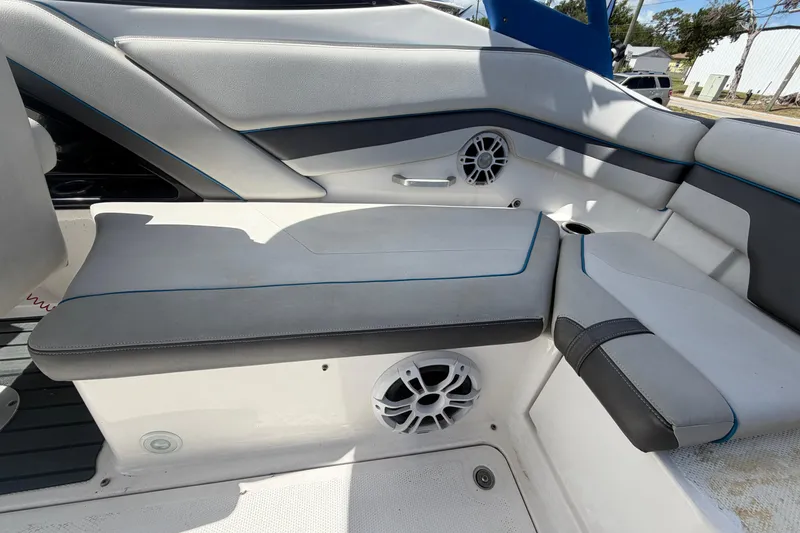 Slide: The Image of 2020 Yamaha Boats AR240 interior seating with speakers and cup holder. - 52