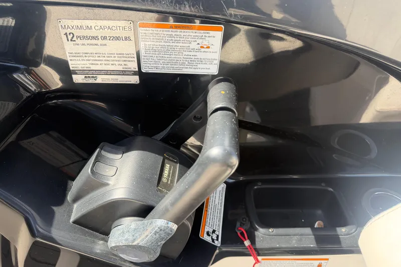 Slide: The Image of Yamaha AR240 boat control panel, showing capacity and warning labels, 2020 model. - 24
