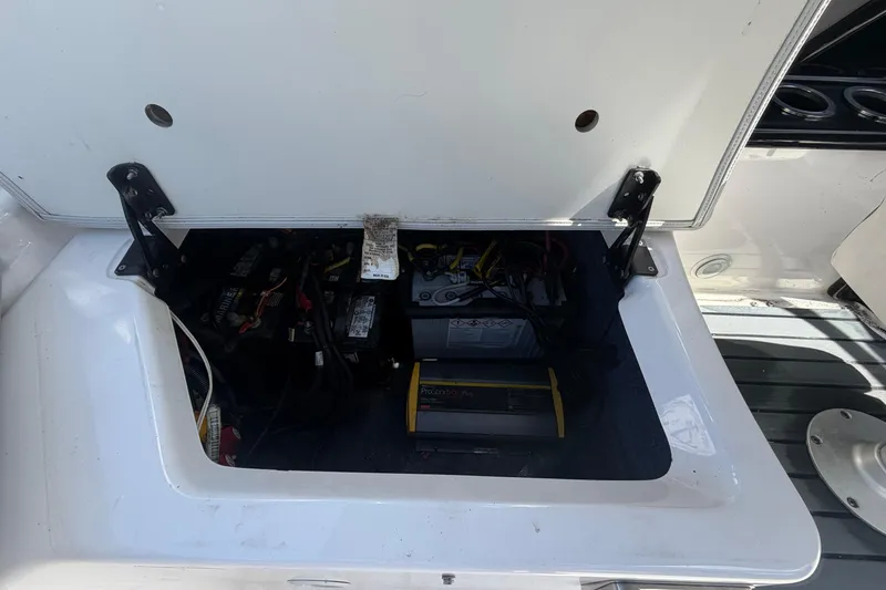 Slide: The Image of 2020 Yamaha AR240 boat battery compartment with wiring and components visible. - 58