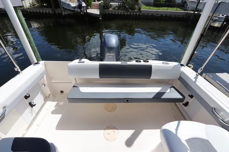 Slide: The Image of 2021 Robalo R227 Dual Console boat interior with seating and outboard motor. - 10