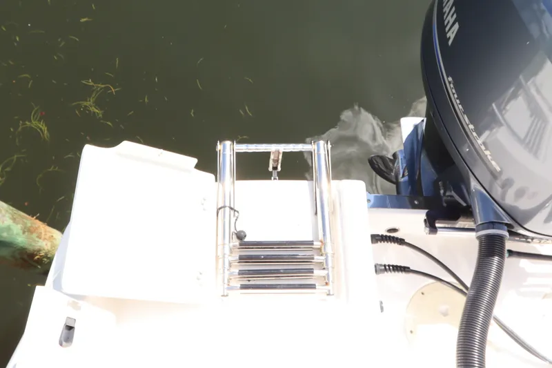 Slide: The Image of 2021 Robalo R227 Dual Console boat with Yamaha engine and swim ladder. - 5
