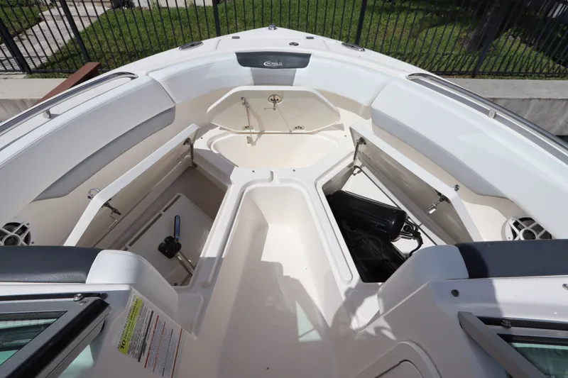 Slide: The Image of 2021 Robalo R227 Dual Console boat interior with open storage compartments. - 23