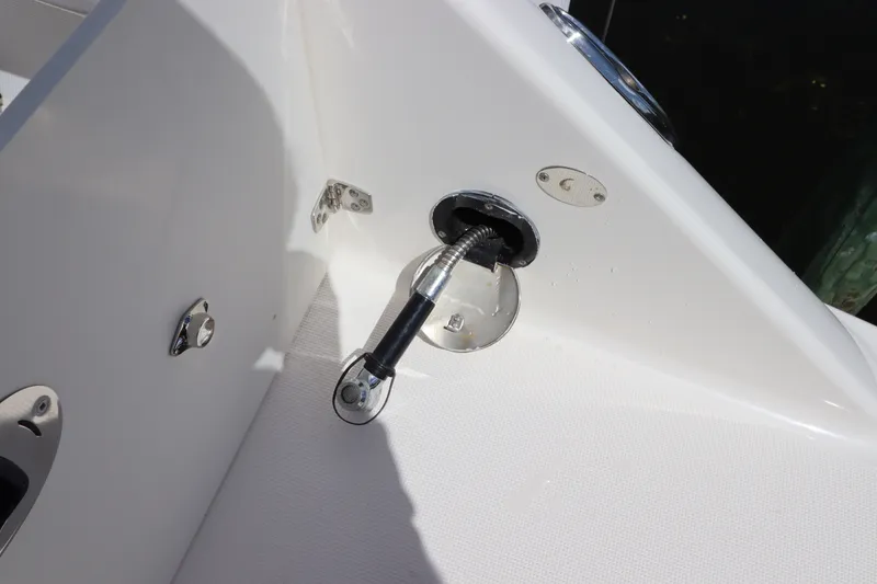 Slide: The Image of 2021 Robalo R227 Dual Console boat detail, featuring a sleek white interior and chrome fittings. - 4