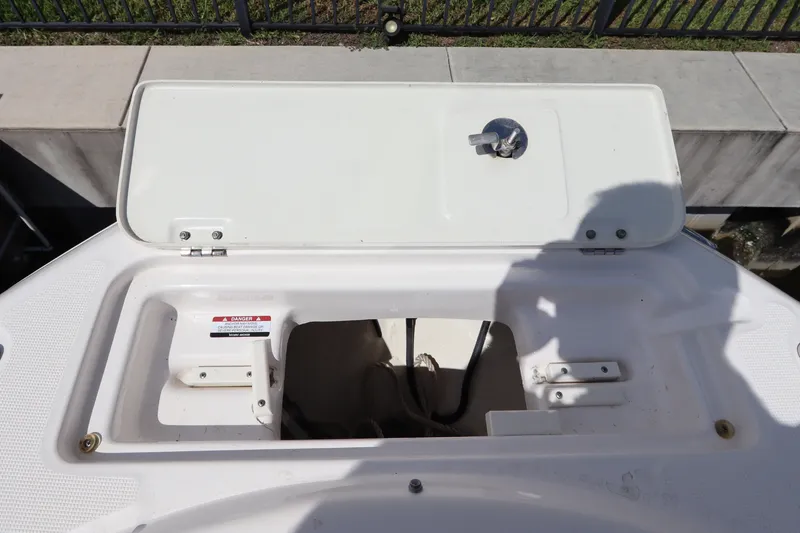 Slide: The Image of Open storage compartment on 2021 Robalo R227 Dual Console boat. - 24