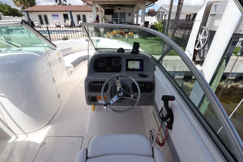 Slide: The Image of 2021 Robalo R227 Dual Console boat cockpit with steering wheel and dashboard controls. - 20