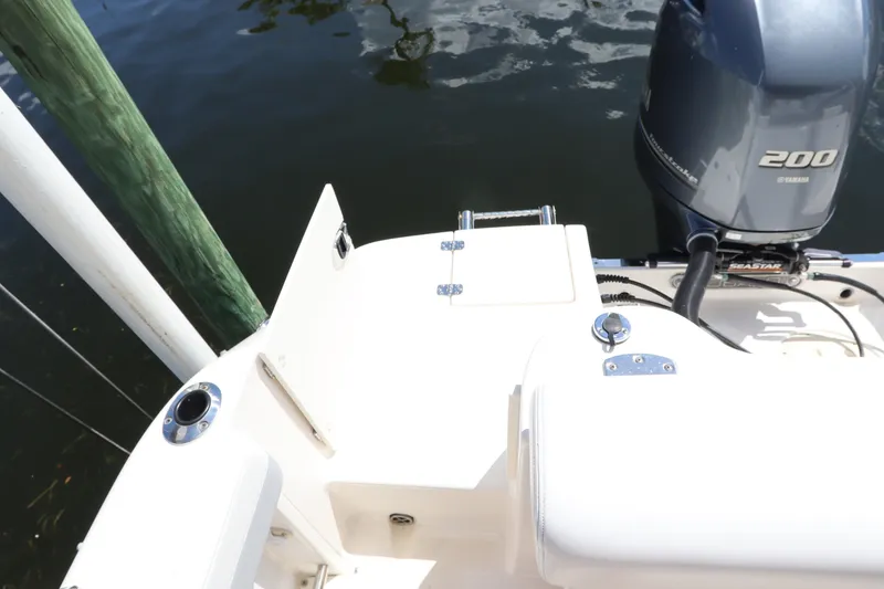 Slide: The Image of 2021 Robalo R227 Dual Console boat with Yamaha 200 engine, docked by wooden post. - 3