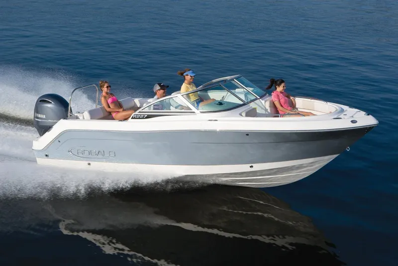 Slide: The Image of Manufacturer Provided Image: 2021 Robalo R227 Dual Console boat cruising on water with passengers. - 26