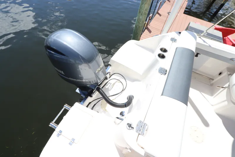Slide: The Image of 2021 Robalo R227 Dual Console boat with Yamaha 200 engine at dock. - 6
