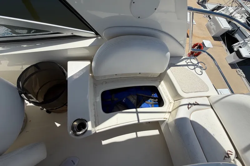 Slide: The Image of 2010 Sea Ray 390 Sedan Bridge interior with storage compartment and seating area. - 45