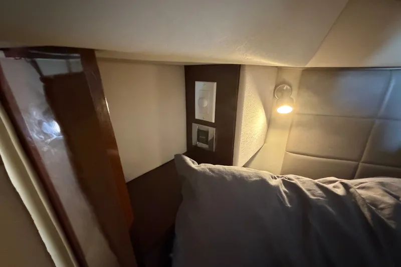 Slide: The Image of Cozy cabin interior of 2010 Sea Ray 390 Sedan Bridge with reading light and pillow. - 109