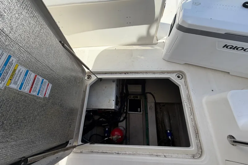 Slide: The Image of Open hatch on 2010 Sea Ray 390 Sedan Bridge, revealing engine compartment and equipment. - 149