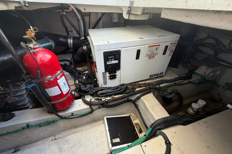 Slide: The Image of Engine room of 2010 Sea Ray 390 Sedan Bridge with Kohler generator and fire extinguisher. - 144