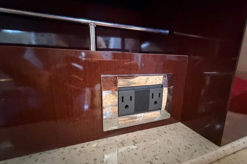 Slide: The Image of Power outlet on polished wood panel, Sea Ray 390 Sedan Bridge 2010 interior. - 77