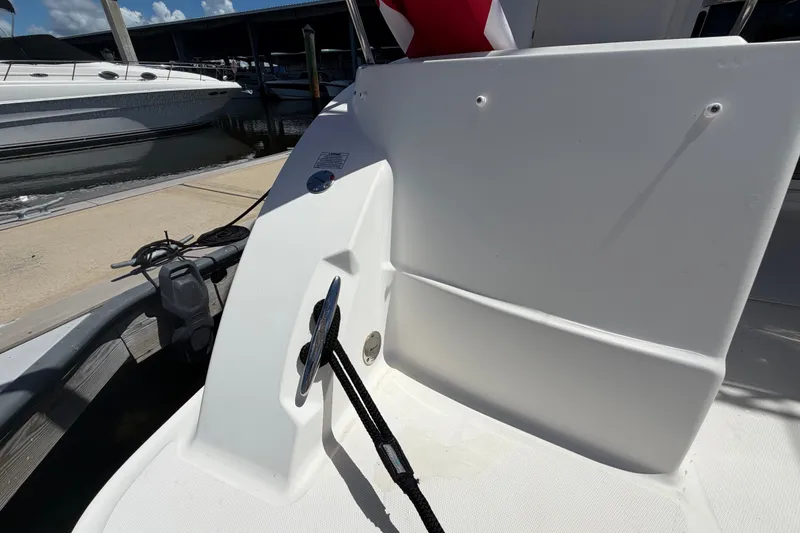 Slide: The Image of 2010 Sea Ray 390 Sedan Bridge boat docked, showing deck cleat and mooring line. - 22