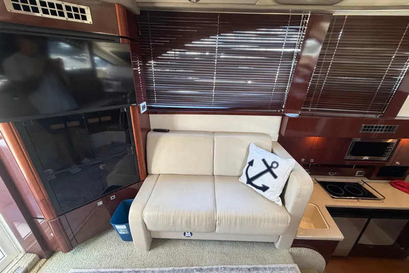 Slide: The Image of Interior of 2010 Sea Ray 390 Sedan Bridge with sofa, anchor pillow, and modern amenities. - 54