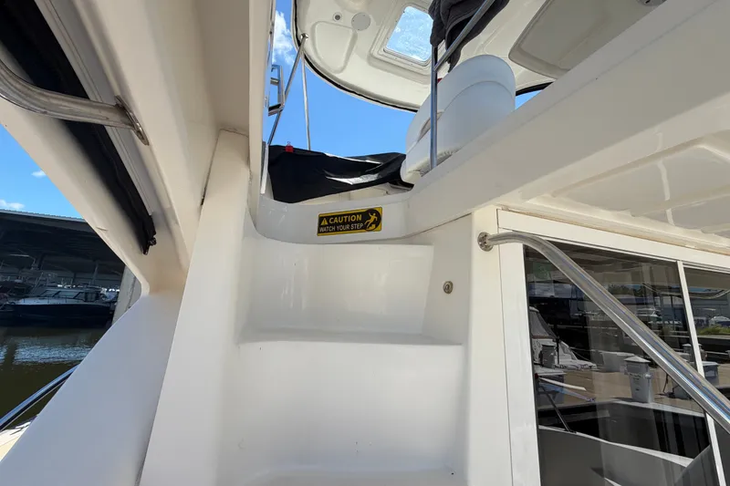 Slide: The Image of Staircase on 2010 Sea Ray 390 Sedan Bridge yacht with caution sign. - 29