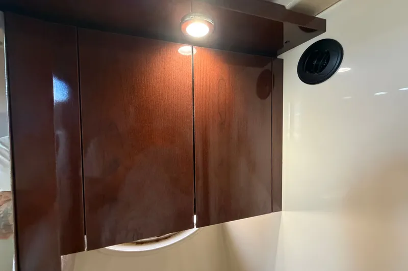 Slide: The Image of Interior cabinet with wood finish and lighting in 2010 Sea Ray 390 Sedan Bridge. - 121