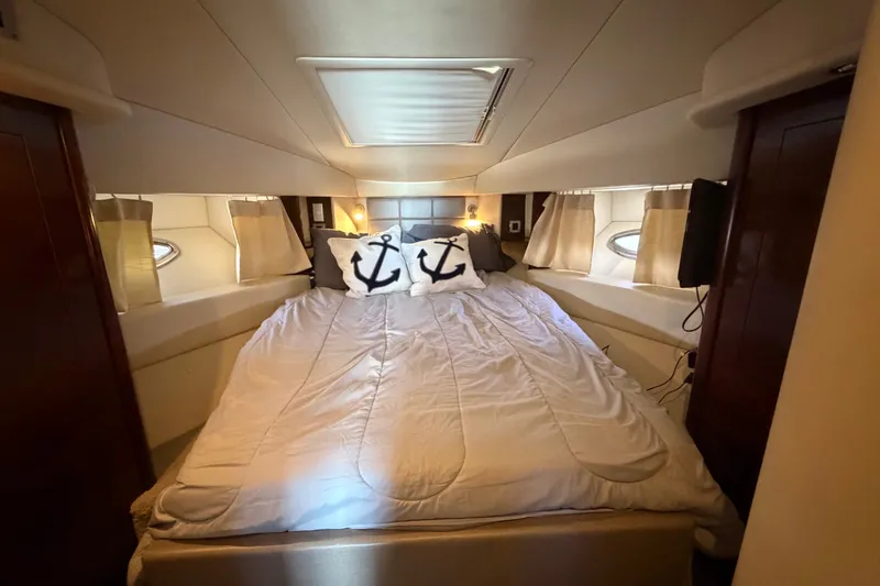 Slide: The Image of Luxurious bedroom interior of 2010 Sea Ray 390 Sedan Bridge yacht with nautical-themed pillows. - 101