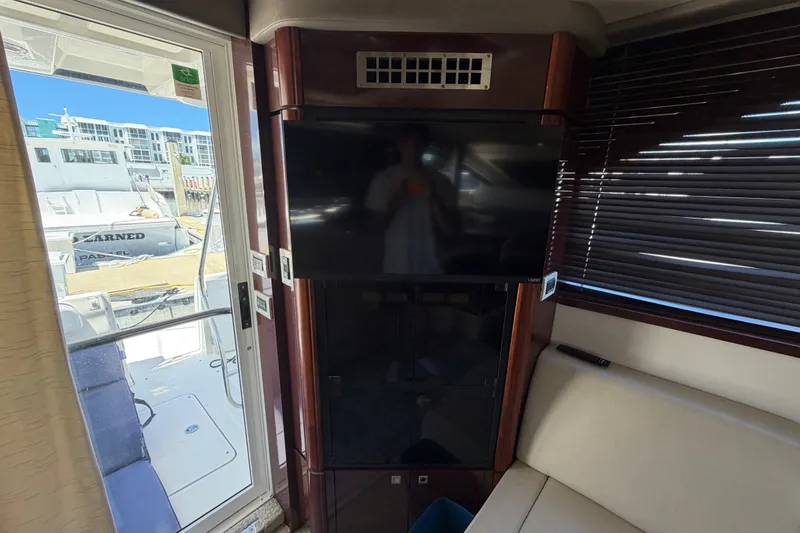 Slide: The Image of Interior of 2010 Sea Ray 390 Sedan Bridge with TV and seating area. - 82