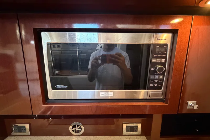 Slide: The Image of Built-in Panasonic microwave in 2010 Sea Ray 390 Sedan Bridge yacht kitchen. - 72
