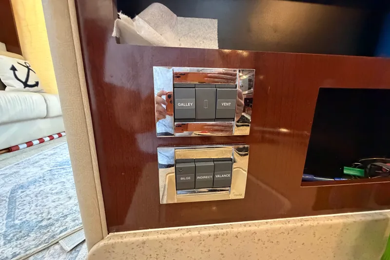 Slide: The Image of Control panel on 2010 Sea Ray 390 Sedan Bridge yacht interior, featuring galley and bilge switches. - 79