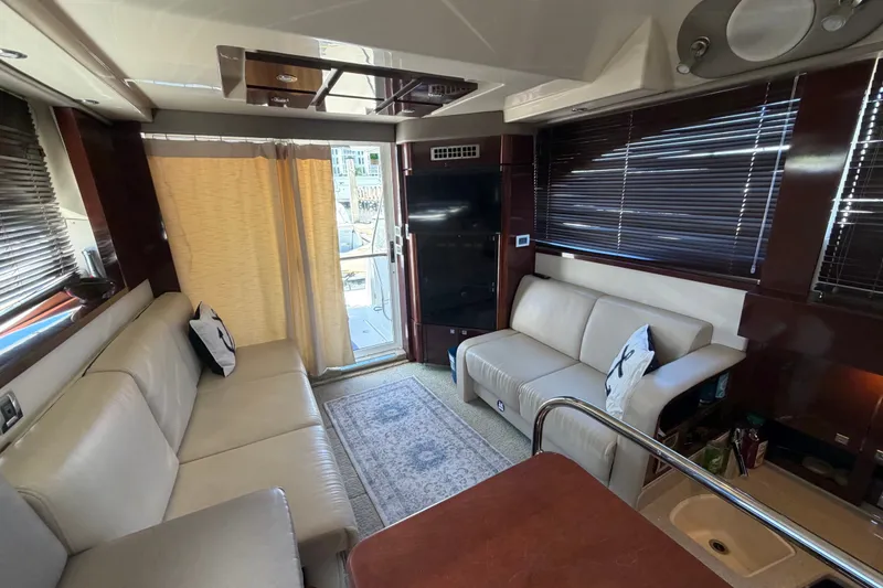 Slide: The Image of Luxurious interior of 2010 Sea Ray 390 Sedan Bridge yacht with leather seating and modern decor. - 90