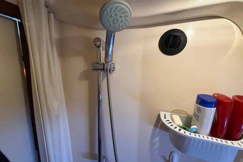 Slide: The Image of Shower area in 2010 Sea Ray 390 Sedan Bridge with toiletries and adjustable showerhead. - 118