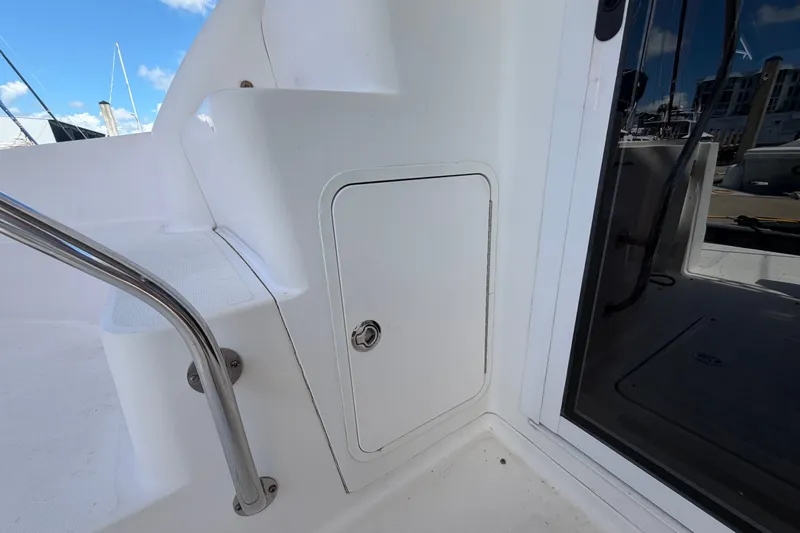 Slide: The Image of 2010 Sea Ray 390 Sedan Bridge boat deck with storage compartment and railing. - 23