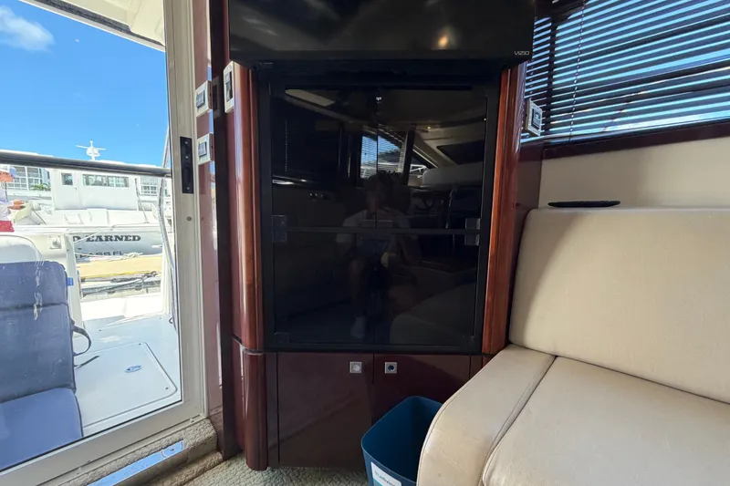 Slide: The Image of Interior of 2010 Sea Ray 390 Sedan Bridge yacht with seating and entertainment area. - 83
